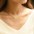 model wearing a gold Custom Birthstone Name Bar Necklace