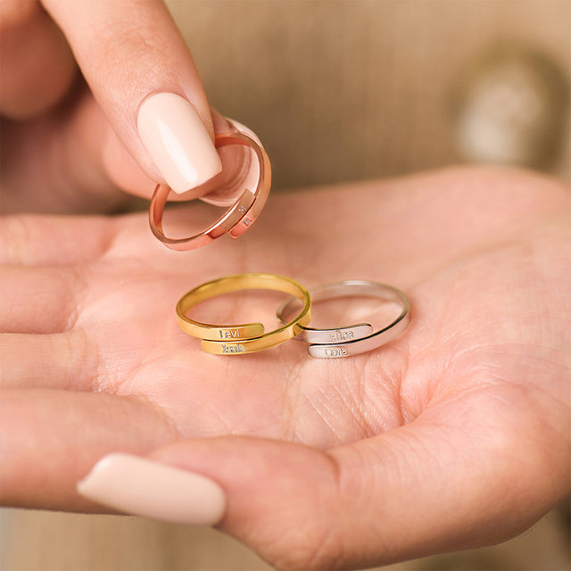 model holding rose gold, gold, and silver Custom Double Name Wrap Rings