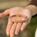 Grandmother & Granddaughter ‘Be Brave and Be Strong’ Blossom Knot Bracelet holding the purple bracelet