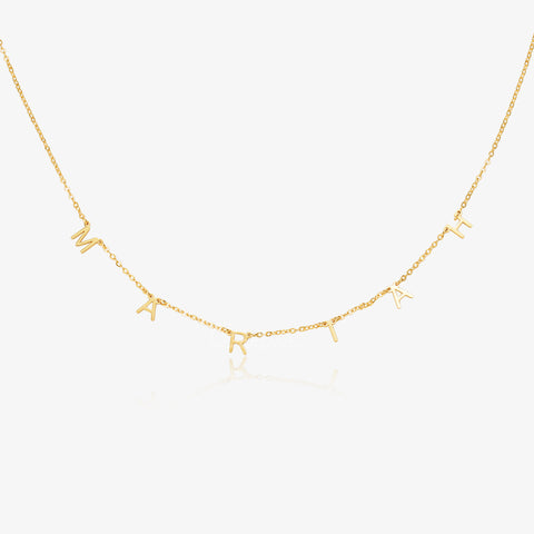 gold colored Personalized Dangling Letter Necklace on white background