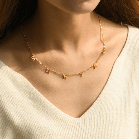 model wearing a gold colored Personalized Dangling Letter Necklace