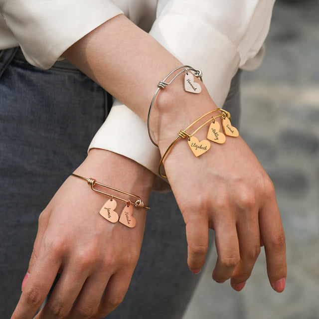 model wearing silver, gold, and rose gold Personalized Heart Name Bracelets