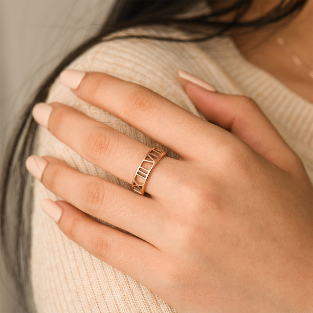 model wearing a gold-colored Personalized Roman Numerals Ring