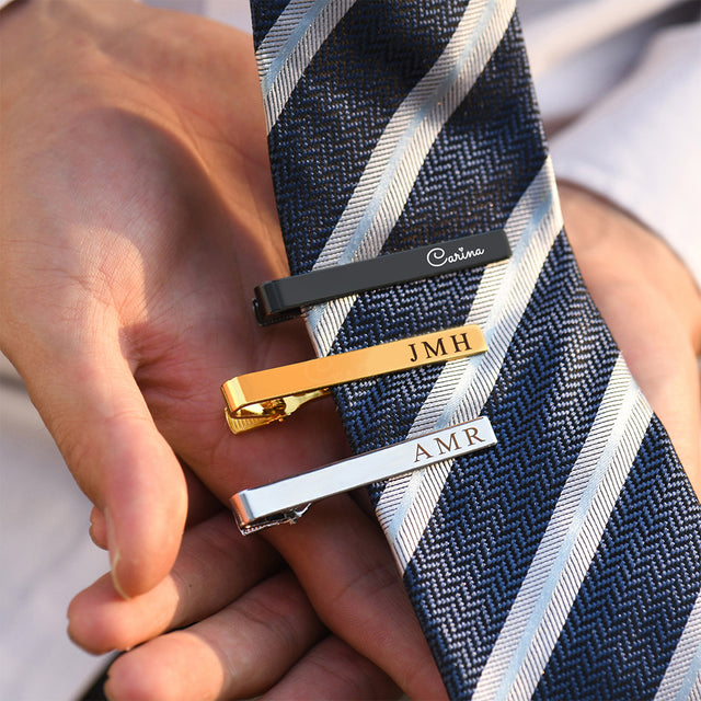 black, gold, and silver Personalized Tie Clips on model's neck tie