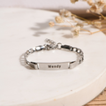 silver Personalized Baby Bracelet on white disc with flowers