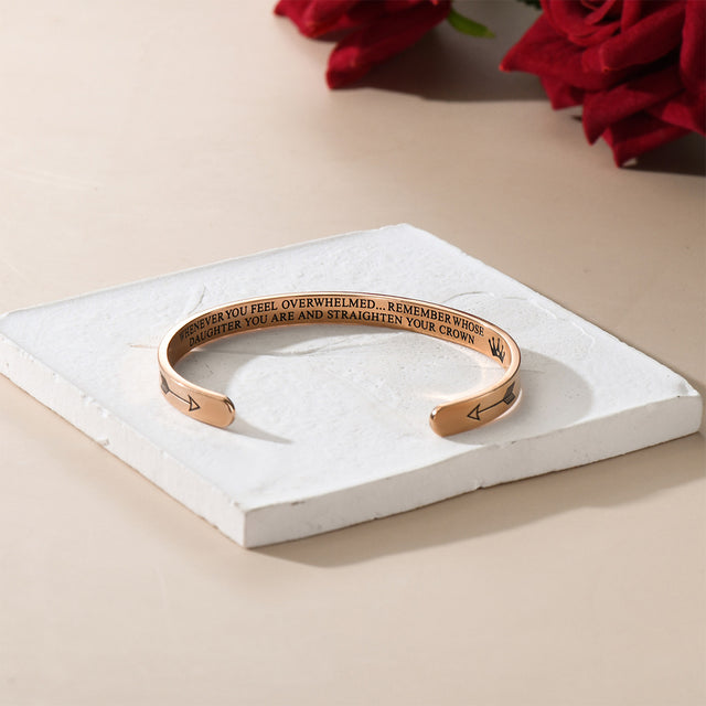 rose gold Straighten Your Crown Personalizable Cuff Bracelet on white square disc with red roses at the back