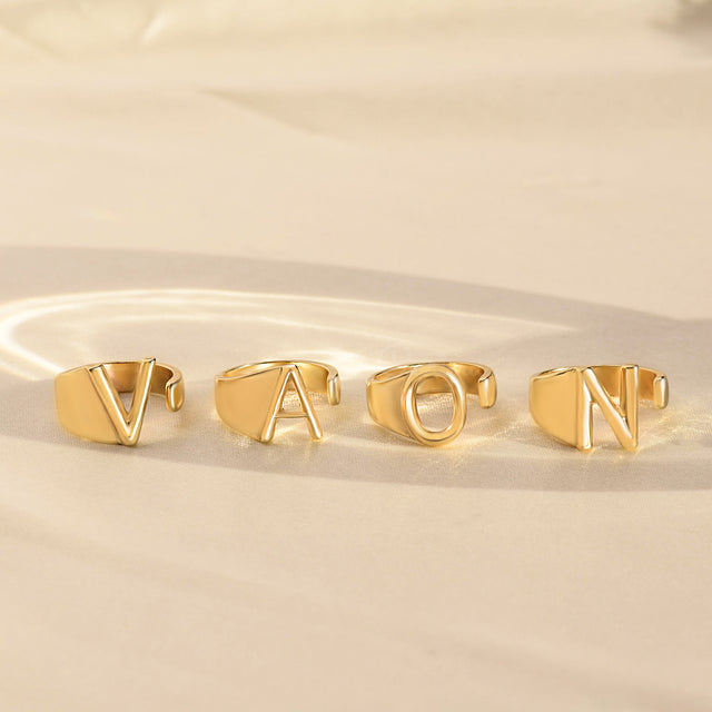 Lifestyle image of Hug From Heaven Personalized Initial Rings with individual initials V, A, O, and N.