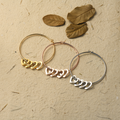 Personalized Hearts Charm Bracelet lifestyle image featuring the gold, silver, and rose gold variants