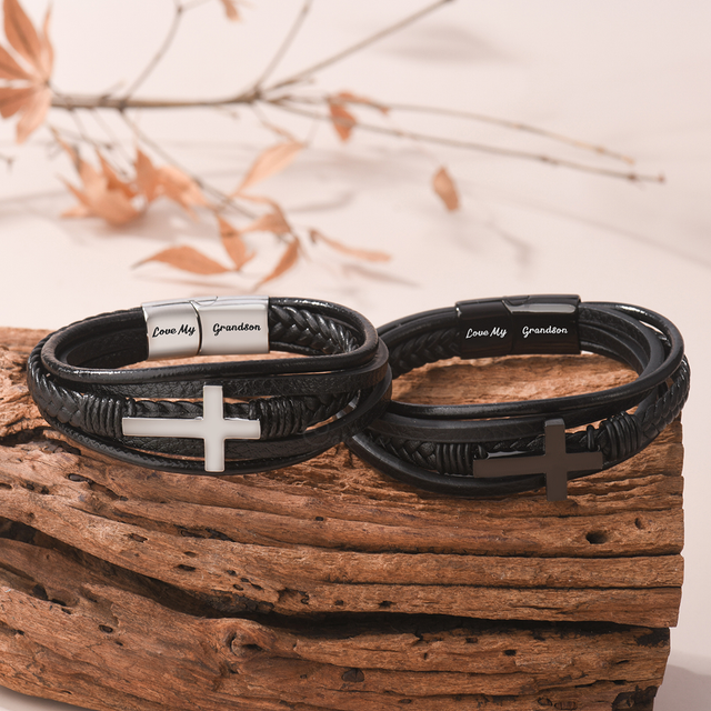 Creative image of the Silver cross and Black cross variants of the leather cross bracelet on a log