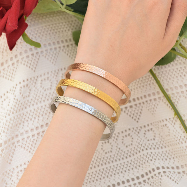 All 3 color variants of the Personalized Hammered Edge Cuff Bracelet on model's wrist