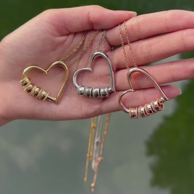 creative video shot of the personalized charming heart necklace with engraved beads