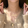 Gold Personalized Fairy Name Necklace held by a lady model.