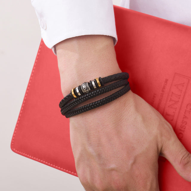 To My Son Love You Forever Bracelet worn by a male model holding a red book