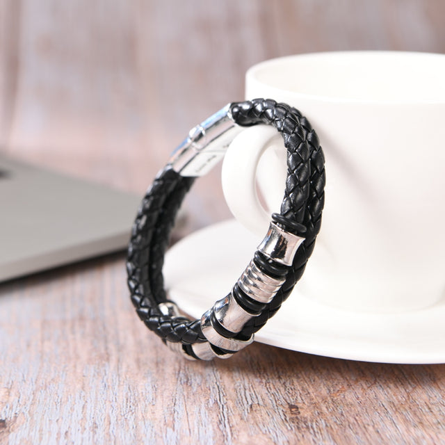 To My Grandson "I Am So Proud Of You" Bracelet beside a cup