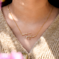 Female model wearing the Dainty Paris Name Necklace